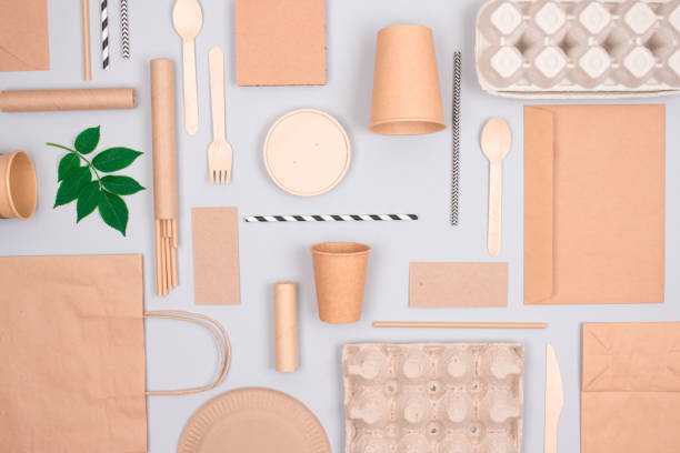 istock Flat lay composition with eco-friendly tableware - kraft paper food packaging on light grey background. Street food paper packaging - cups, plates, straws, containers and paper bags. Mockup 1282326020