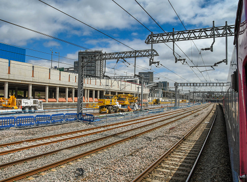 London, England - June 2018:  View from a train of new gantries and overhead cabling installed for the electrification of the main line from London to Wales and the South West of England