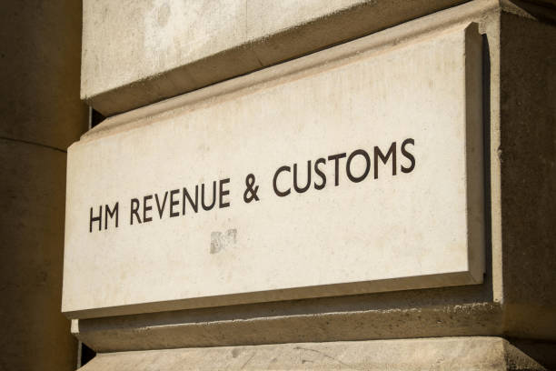 Sign outside the door of the HM Revenue and Customs headquarters in London London, England - June 2018:  Sign outside the HM Customs and Revenue department of the British Government in Whitehall, London. The letters are engraved into the  block of stone. hm government stock pictures, royalty-free photos & images