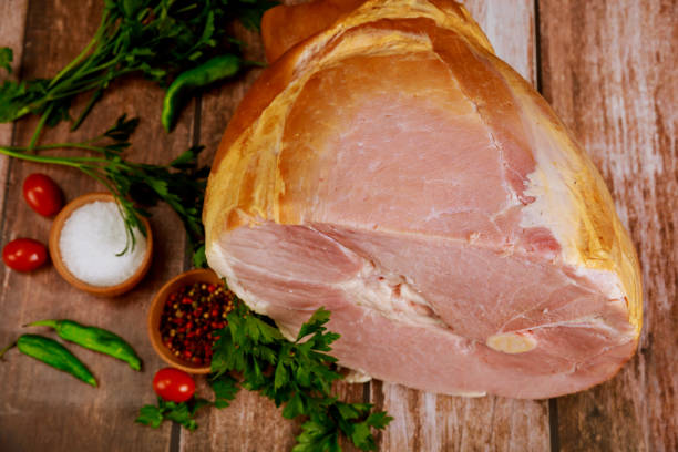 istock Whole pork ham with fresh parsley, hot pepper and salt. 1282326864