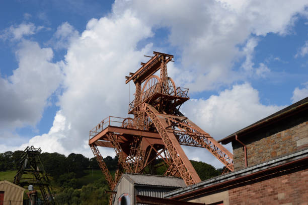 Rhondda Valley, Wales - August 2017: One of the pit head wheels and winding gear of the old Lewis Merthyr colliery, which is now the Rhondda Heritage Park in Porth, Rhondda, which is now a historical mining experience