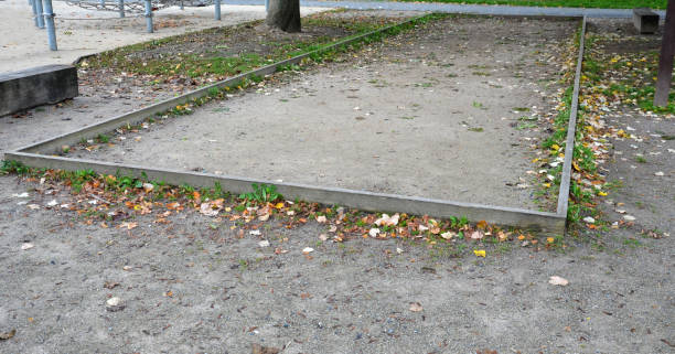 istock old neglected playground area rectangular for petanque. wood planked area for playing with metal balls. mostly in public parks throughout France. retirement game 1282327425