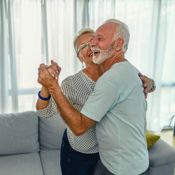 istock Senior couple dancing at home 1282327480