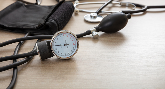 Blood pressure measure equipment, Hypertension control. Medical stethoscope and sphygmomanometer on doctor office desk, closeup view.