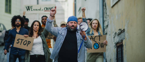 istock Group of people activists protesting on streets, strike and demonstration concept. 1282327831