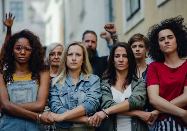 Group of people activists protesting on streets, women march and demonstration concept. Portrait of group of people activists protesting on streets, women march and demonstration concept. protest stock pictures, royalty-free photos & images