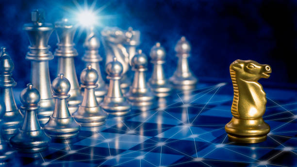 istock Golden knight chess is leadership in front off silver chess pieces on chess board with network and communication 
flare light to fighting with teamwork to victory, business strategy concept for success. 1282328231