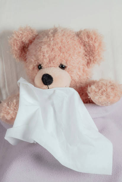 istock Cold, flu or allergy. Cute teddy in bed sneezing 1282328490