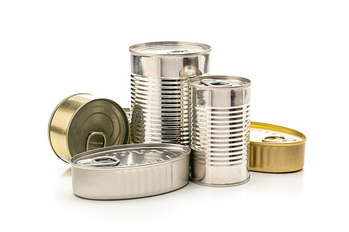 Front view of tins of food of different sizes, colors and shapes isolated on white background. High resolution 42Mp studio digital capture taken with SONY A7rII and Zeiss Batis 40mm F2.0 CF lens