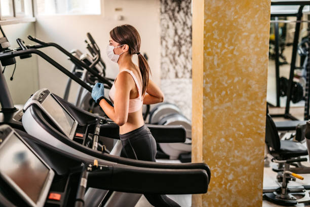 istock Woman running on treadmill in gym 1282330040