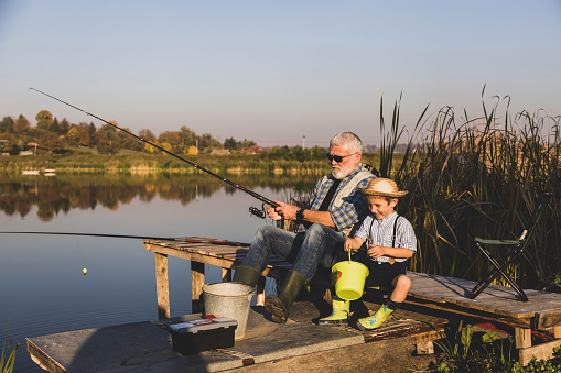 Two kids fishing on the lake shore - Buenos Aires - Argentina