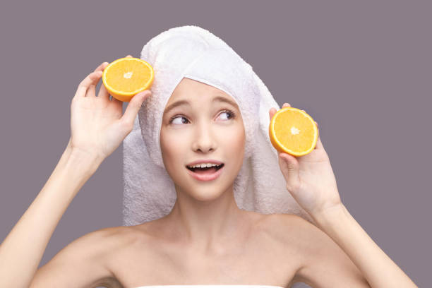 girl hold orange slice. citrus fruit hidding face - hidding imagens e fotografias de stock