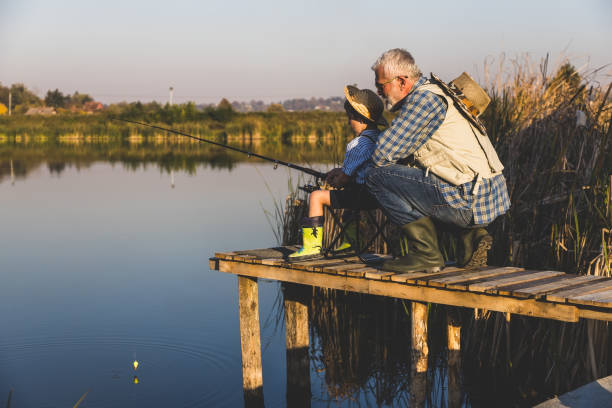 istock Senior man fishing with grandson 1282331297