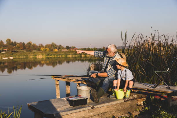 istock Senior man fishing with grandson 1282331298