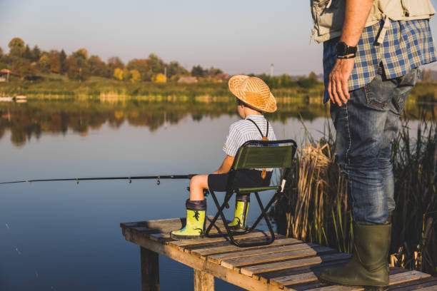 istock Senior man fishing with grandson 1282331388