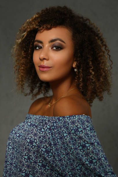 istock Happy young woman with an afro hairstyle 1282332329