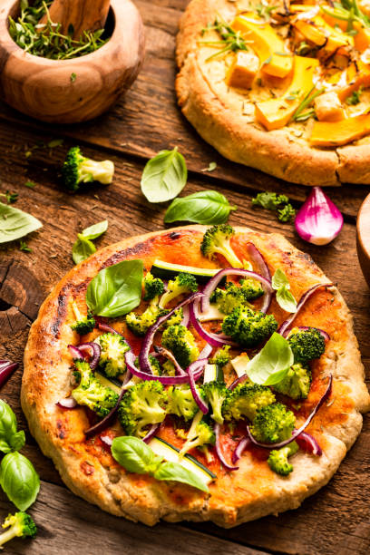 istock Homemade Small Vegetarian Pizza on Wooden Rustic Table. Top Down View 1282332455