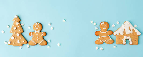 istock Happy New Year's Christmas set of ginger biscuits - man, house, tree glazed sugar icing decoration on blue background, minimal seasonal winter holiday card, banner, flyer, coupon, stay home 1282332465