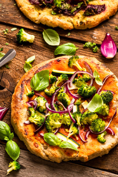 istock Homemade Small Vegetarian Pizza on Wooden Rustic Table. Top Down View 1282332579