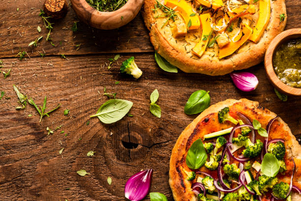 istock Homemade Small Vegetarian Pizza on Wooden Rustic Table. Top Down View 1282333646