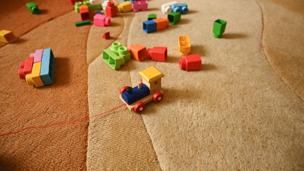 istock Colored toy train, on a background of colored toys 1282334081