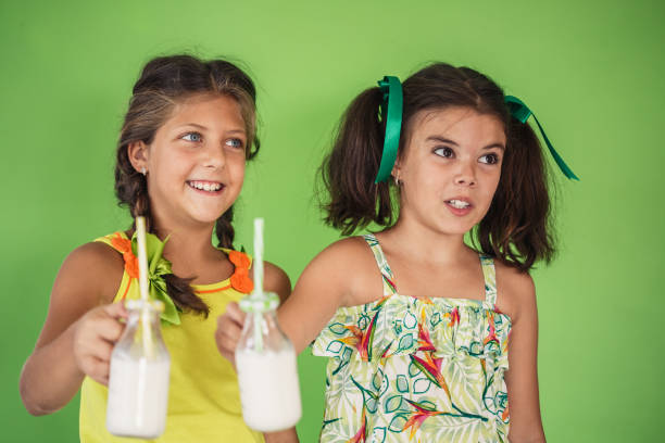 istock Two girls holding reusable bottles with milk 1282334561