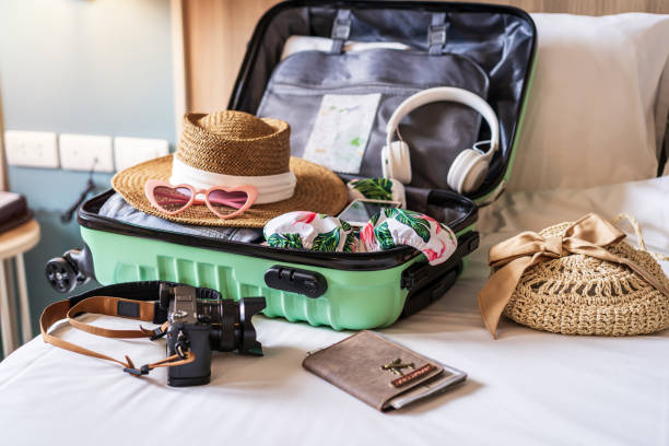 Traveler suitcase and luggage with travel accessories and items preparing for travel stock photo