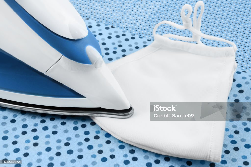 Steam Iron and face mask close up Color Image Stock Photo
