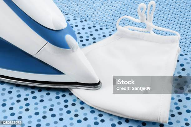 Steam Iron And Face Mask Close Up Stock Photo - Download Image Now - Color Image, Coronavirus, FFP2 Mask