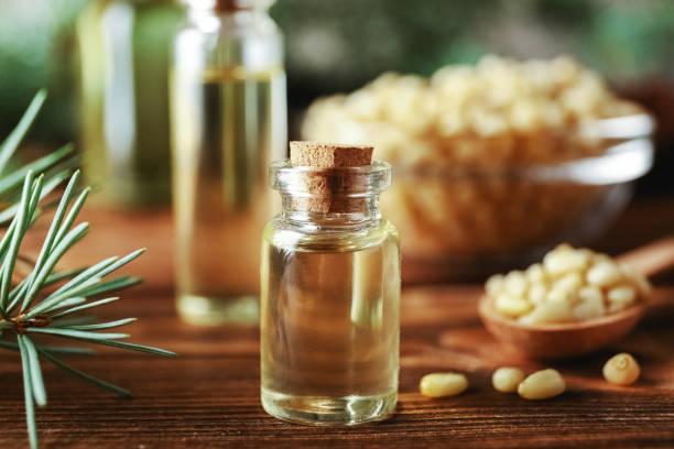 istock Pine nuts and bottles of essential oil. 1282337375