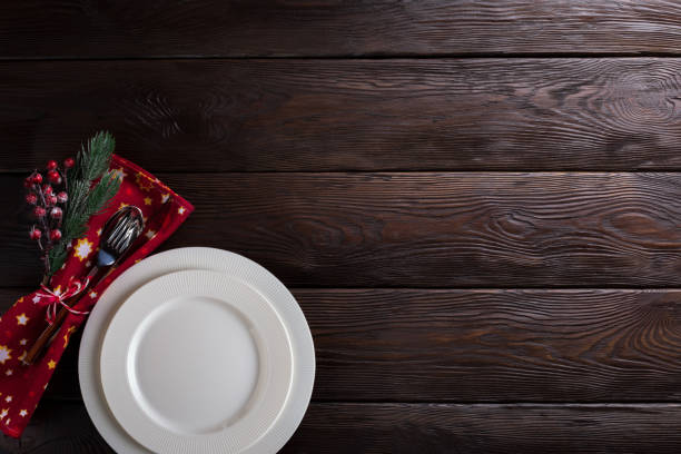 istock Christmas table setting with empty white plates, cutlery and table napkin. 1282337556