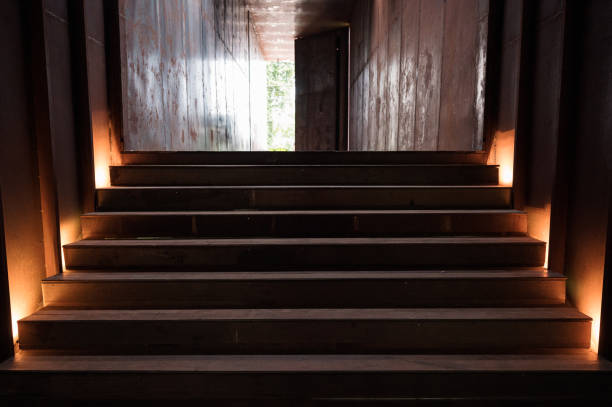 istock Rust staircase with lighting in abandoned metallic corridor and door opening 1282337675