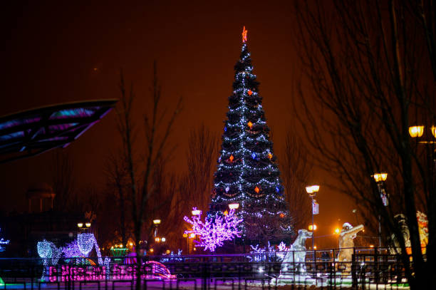 istock snowfall walk down the street past the dressed up festive Christmas tree and colored figures-multi-colored balls 1282338554