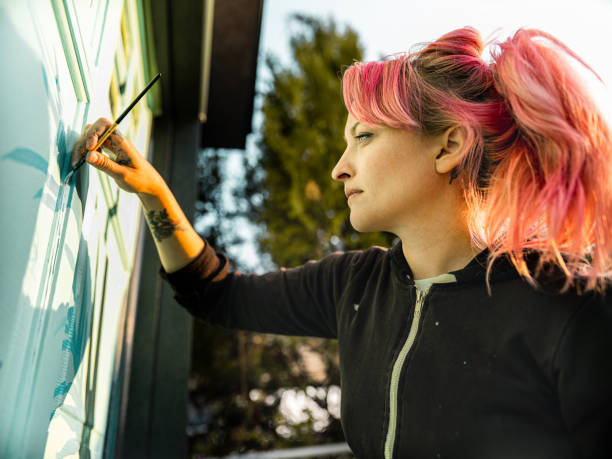 istock Female mural artist at work 1282339161