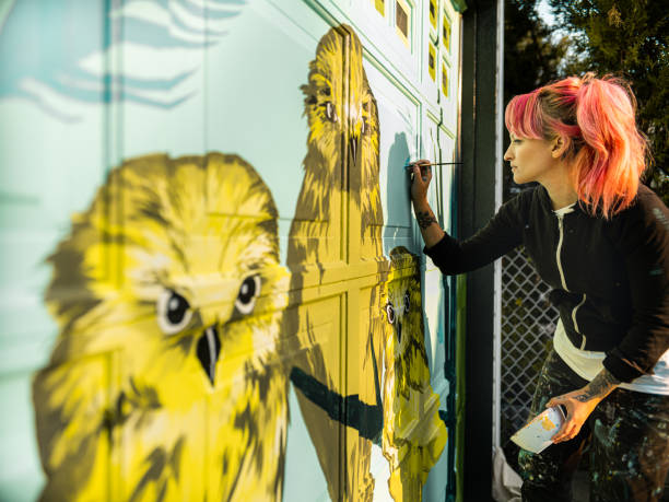 istock Female mural artist at work 1282339173