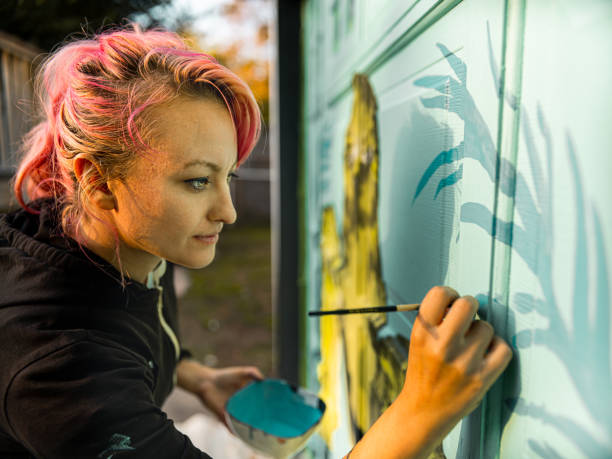 istock Female mural artist at work 1282339248