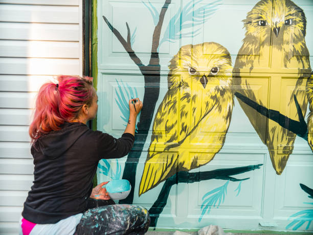 istock Female mural artist at work 1282339356