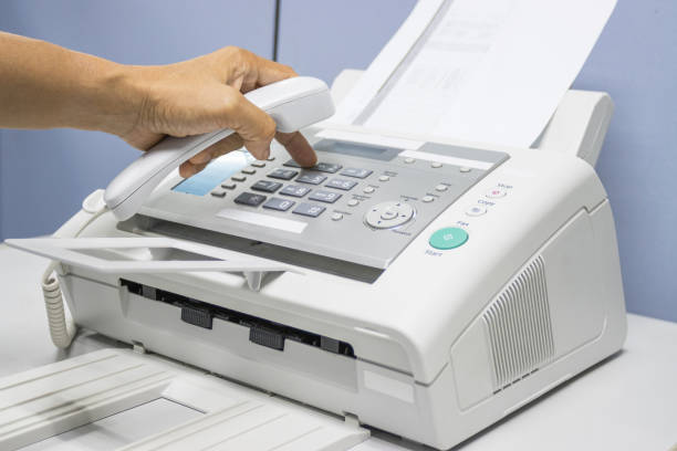 istock hand man are using a fax machine in the office, equipment for data transmission. 1282339418