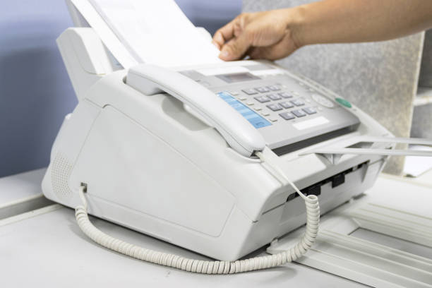 istock hand man are using a fax machine in the office, equipment for data transmission. 1282339445
