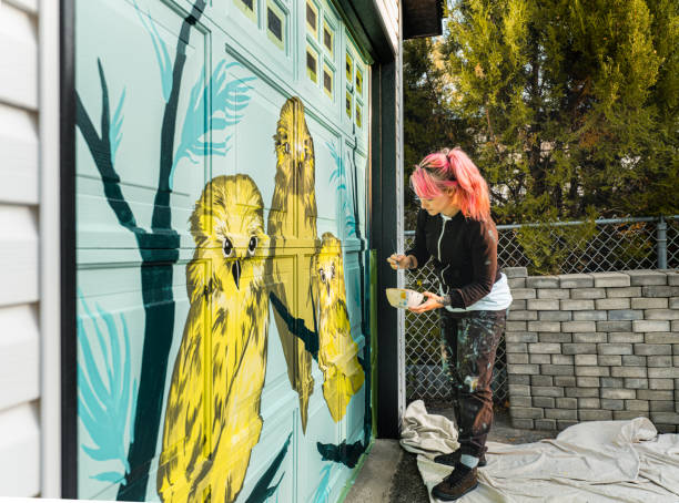 istock Female mural artist at work 1282339564