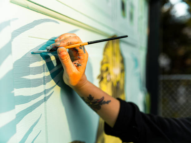istock Female mural artist at work 1282340208