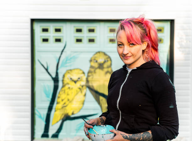 Female mural artist at work