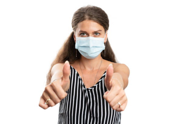 istock Female wearing covid protection mask showing double like gesture 1282340548