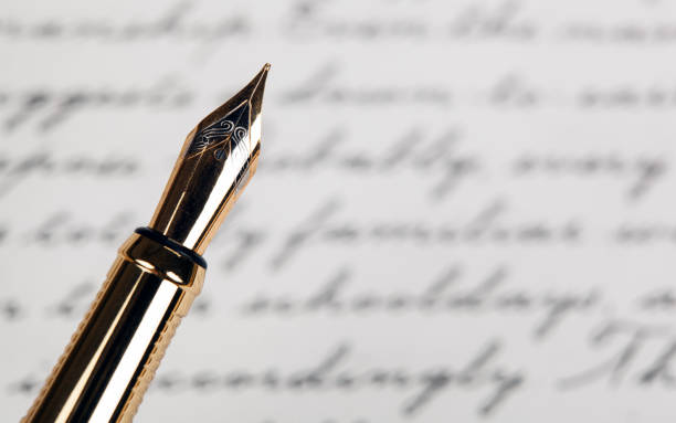 istock fountain pen with ink text background closeup 1282340551