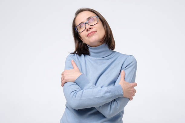 istock Mature woman hugging herself with crosed hands, smiling from pleasure 1282342164