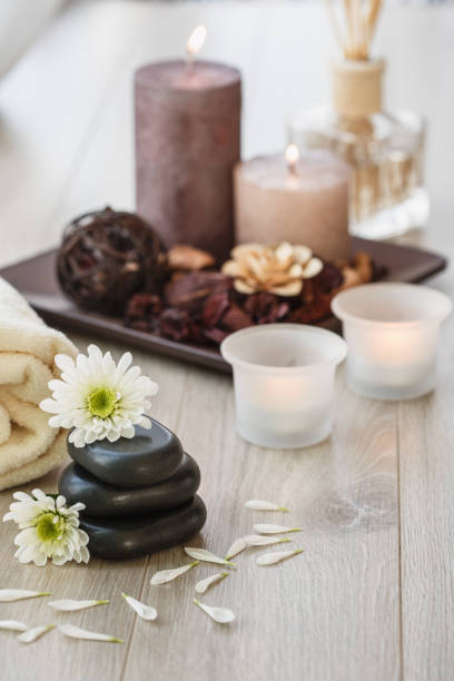 istock Flowers and aromatic candles for this Lastone massage session 1282342365