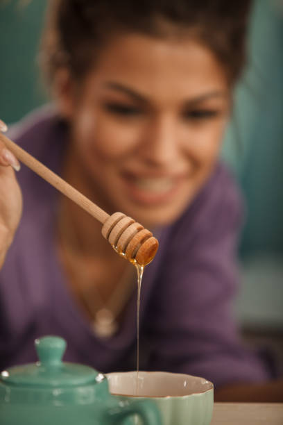 istock Honey dripping into a cup of tea 1282342429