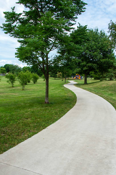 istock A winding park path leads to a distant playground in summer. 1282343500