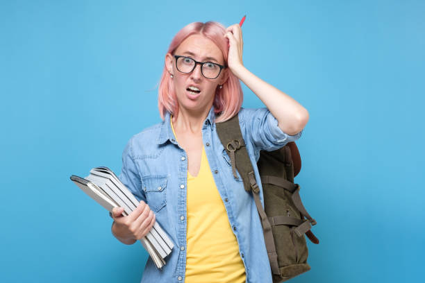 istock Young caucasian woman with glasses scratching head, thinking deeply about something 1282343589
