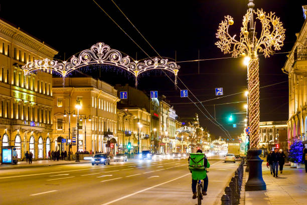 Nevsky Prospect at Saint Petersburg is decorated a bright lights for the New year St. Petersburg, Russia - January 5, 2020: Christmas holiday in Russia. Winter cityscape new year urban scene horizontal people stock pictures, royalty-free photos & images